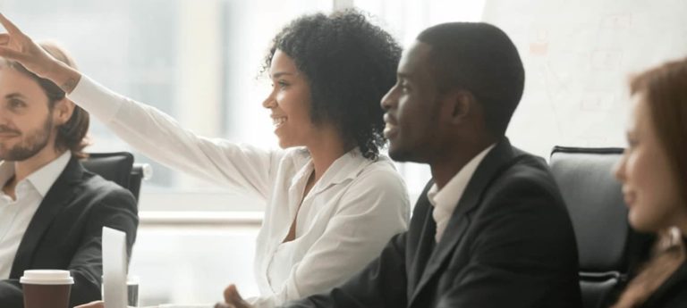 Managers in training session raising hands - Safety Managers Training Course from Phoenix STS